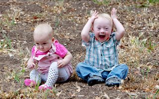 Two siblings play together, one has down syndrome.