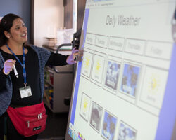 Ana Tamayo, Assistant Aide, reports on the weather for students at A.C.C.E.S.S. Secondary School. Moorpark, California.