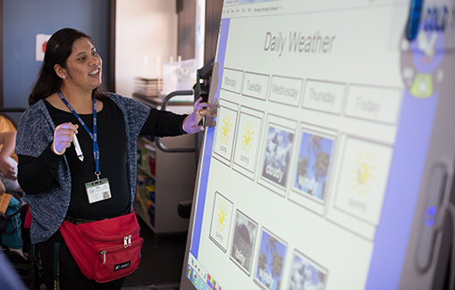 Ana Tamayo, Assistant Aide, reports on the weather for students at A.C.C.E.S.S. Secondary School. Moorpark, California.