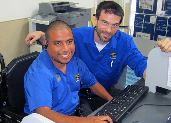 Photo of Jonathon Rosales at work at Best Buy with his colleague Gil