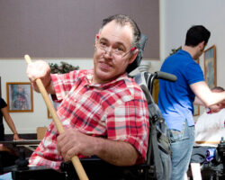 Man does therapy with a stick in a group home day program