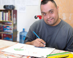 Man with disabilities draws during a day program