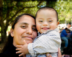 Hispanic mom holds her infant close