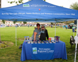 Two TCRC staff man the TCRC booth at an event