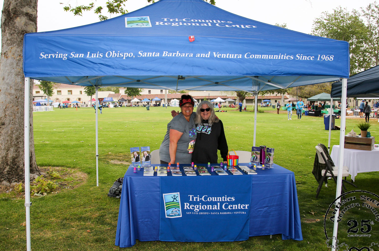 Two TCRC staff man the TCRC booth at an event