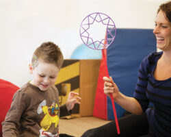 Boy enjoys making bubbles as reward in behavioral therapy