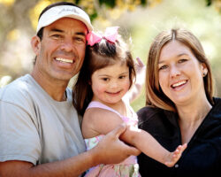 Close up of Dad and mom holding toddler with down syndrome