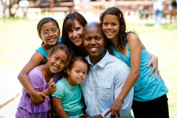 Mixed race family of six squeeze in for a photo