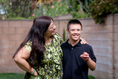 Asian mom questions smiling teenage son