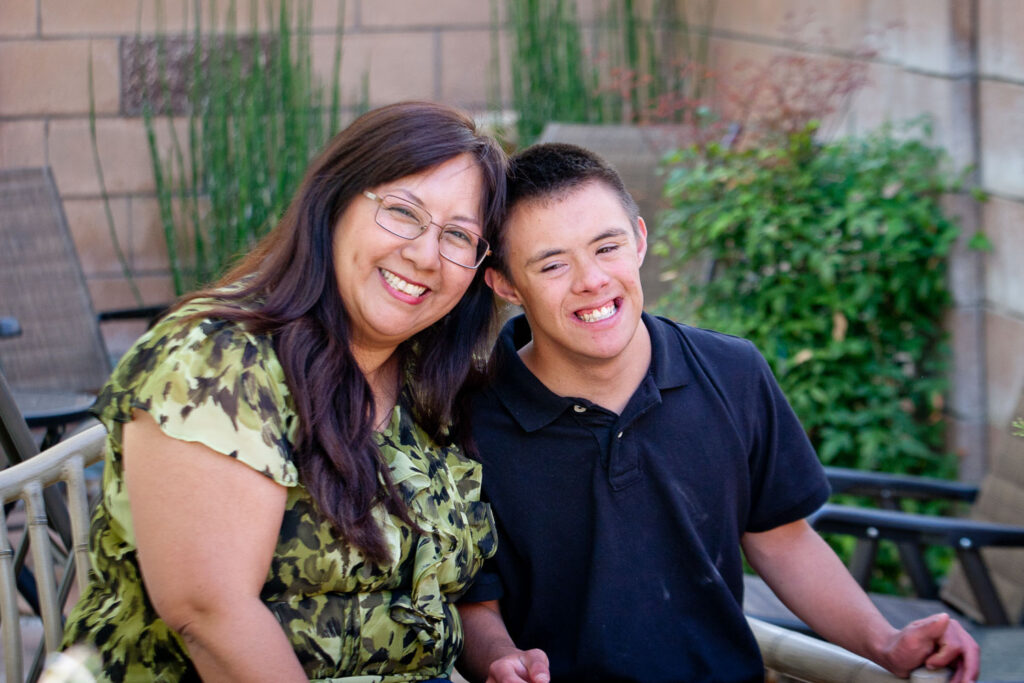 Asian mom hugs teenage son