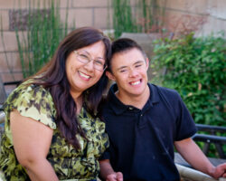 Asian mom hugs teenage son