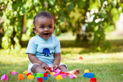 Portrait of a little african american baby boy playing outdoor in the grass