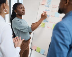 Three service providers put notes on a whiteboard