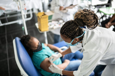 Young woman with special needs getting vaccinated in a medical clinic