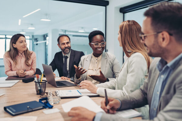 Group of stakeholders have a discussion at a conference table