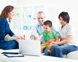 Mixed race family meets with Service Coordinator in their home