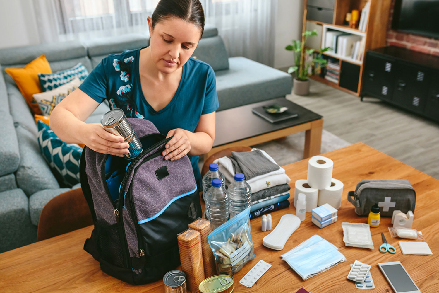 Woman creating a go-kit for emergency