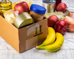 Photo of non-perishable food items, some in a small box and others on a table